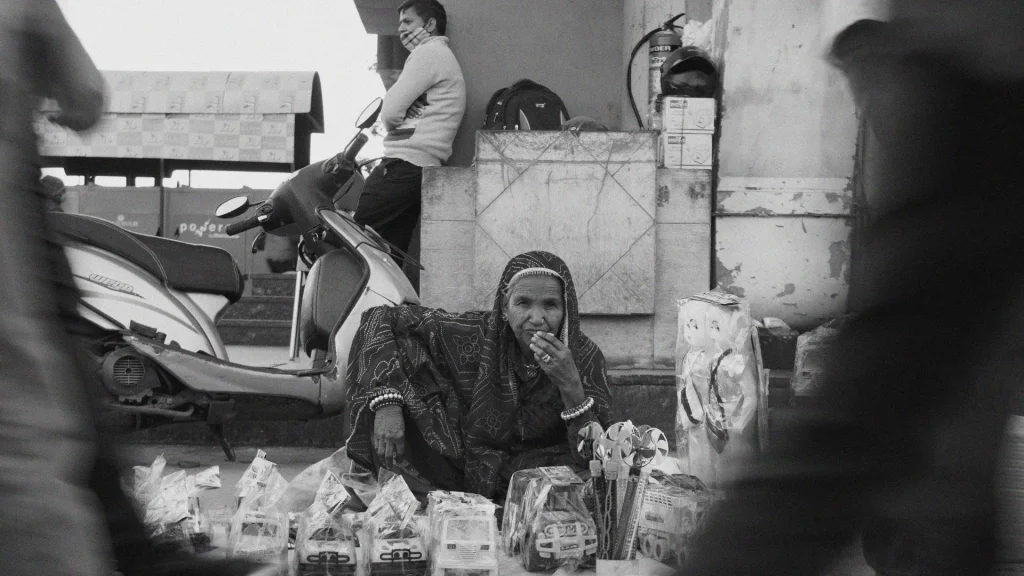 Local Street Vendor Market India Elderly local street vendor selling toys, everyday street life in an Indian market