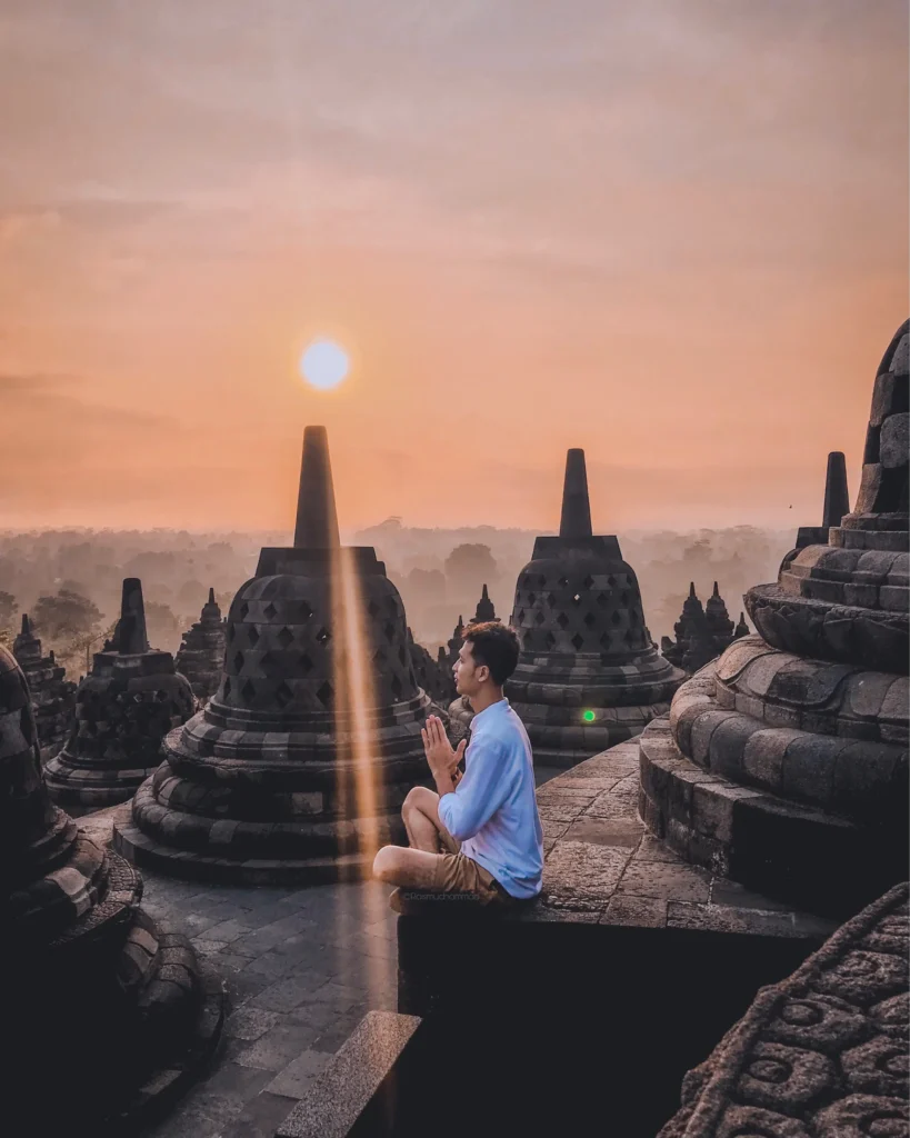Woman in White Shirt Sitting on Gray Concrete Floor during Sunset